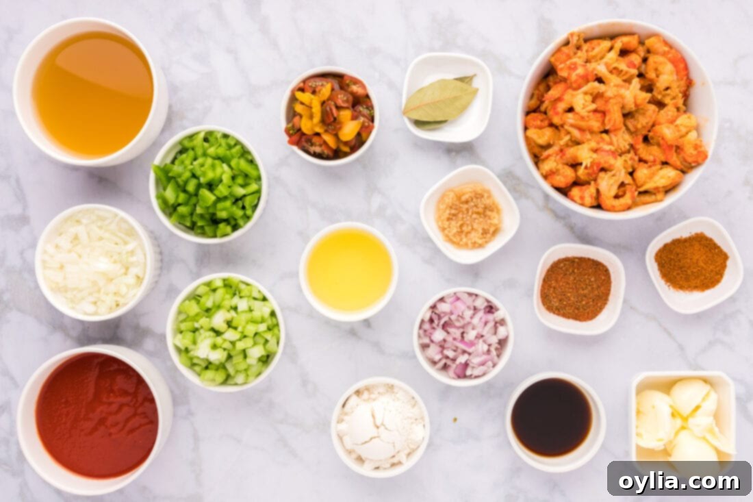 A selection of fresh ingredients including crawfish, vegetables, and seasonings, laid out for Crawfish Etoufee.