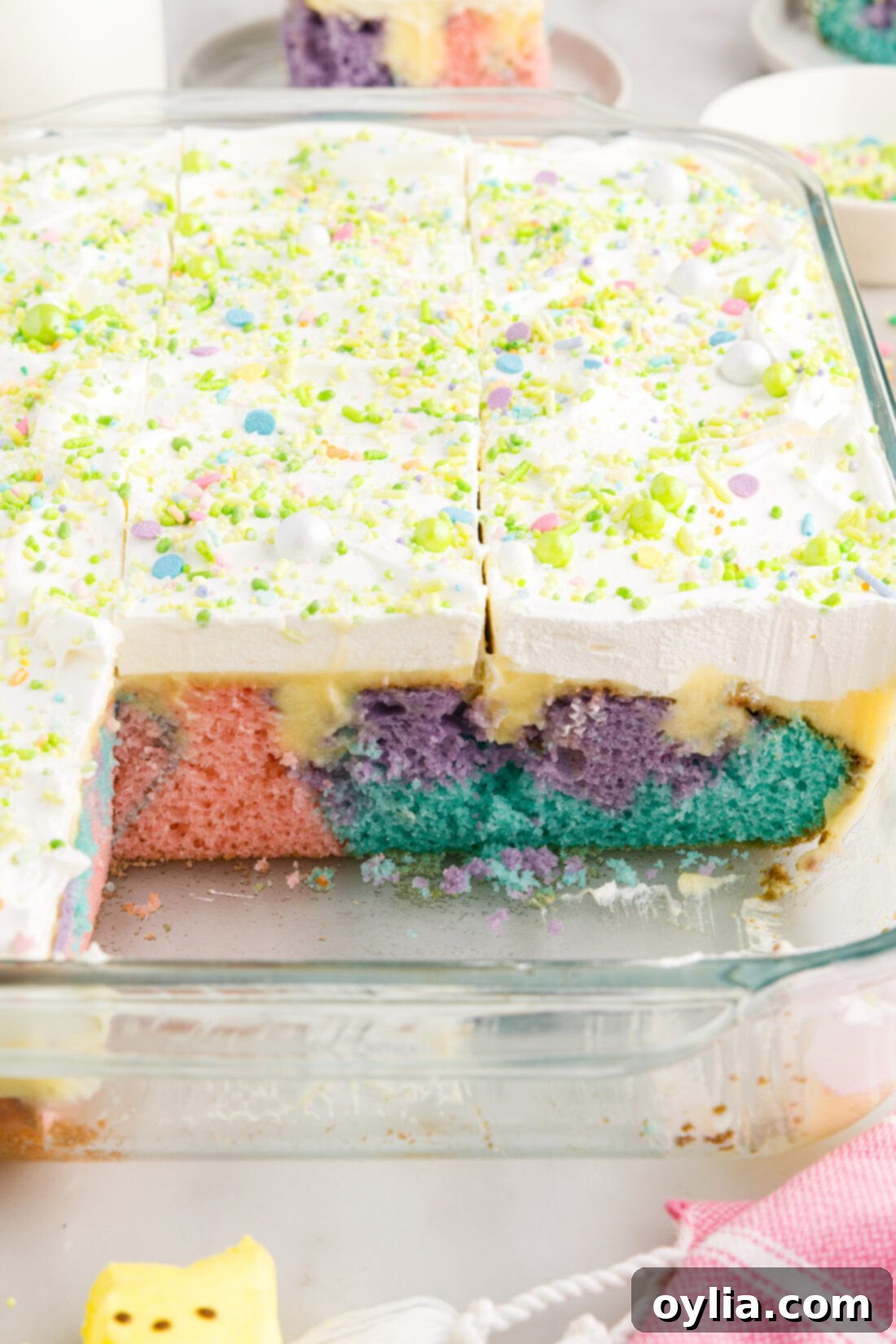 Easter Poke Cake in a 13x9 baking dish with two pieces removed