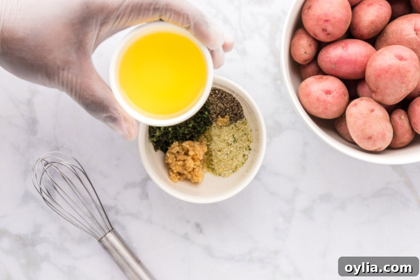 olive oil over a bowl of seasonings
