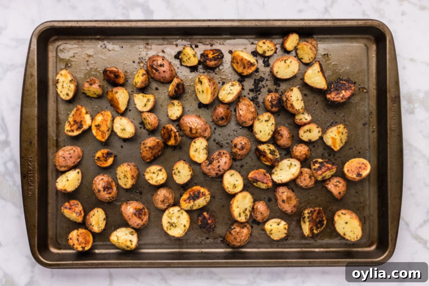 overhead shot of roasted red potatoes on a baking sheet