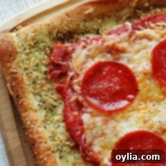 A close up photo of garlic bread crusted classic pizza.
