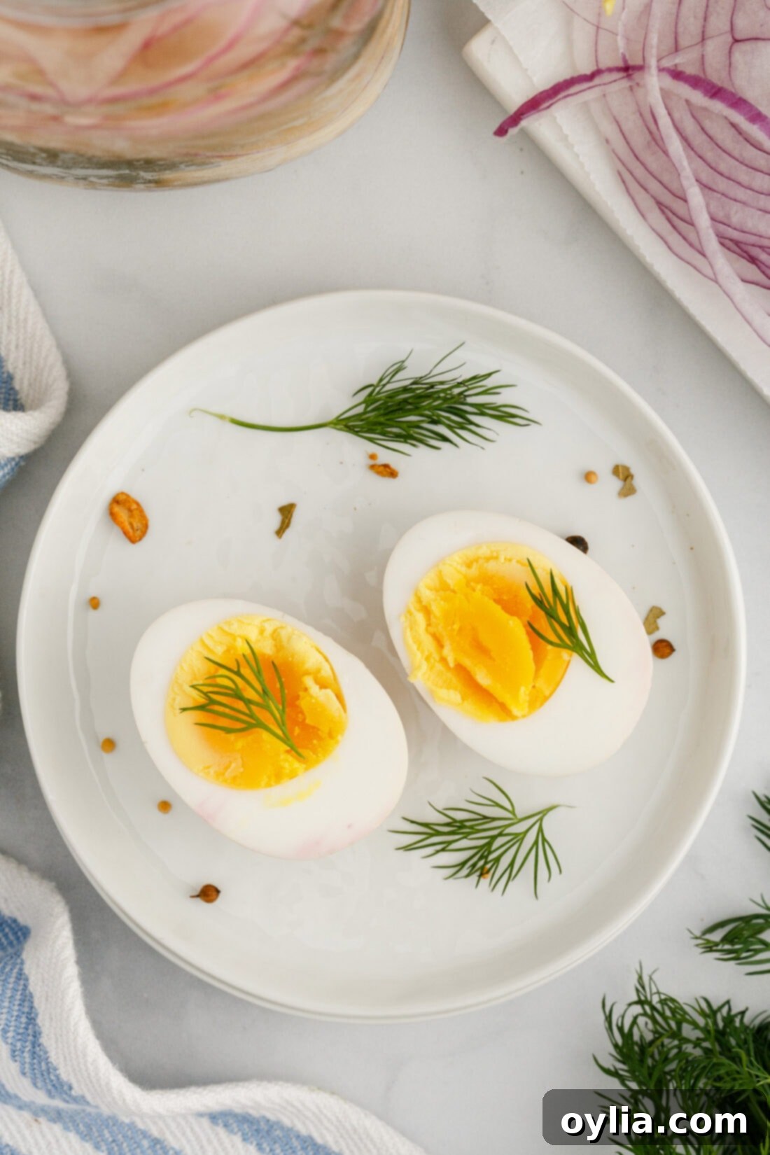 A Pickled Egg cut in half on a plate, showing the yolk and white