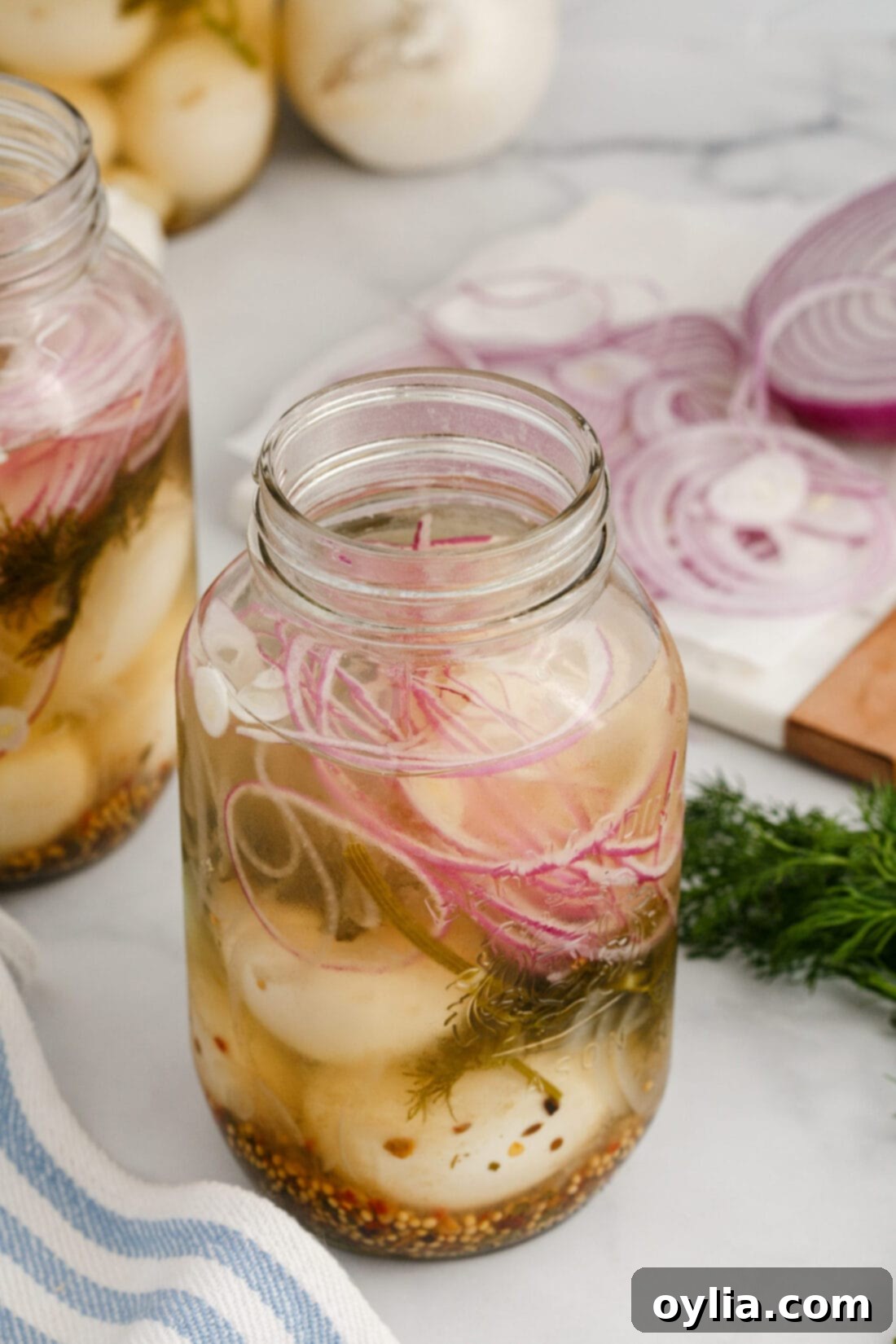 Jar of Homemade Pickled Eggs with dill and onion