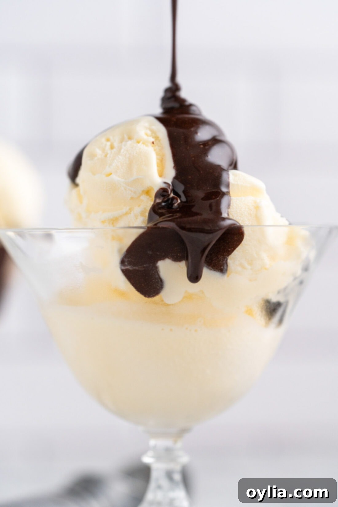 Hot Fudge being drizzled over ice cream