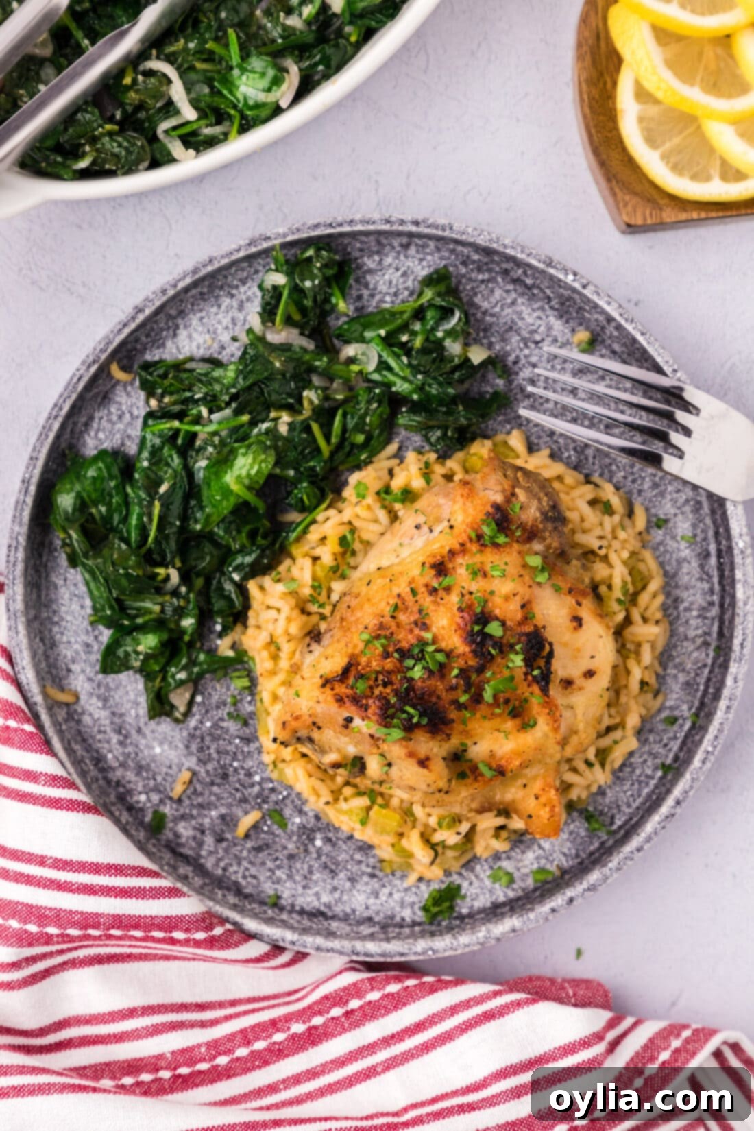 Instant Pot Chicken Thigh on a plate with sautéed spinach, showcasing crispy skin and juicy meat.