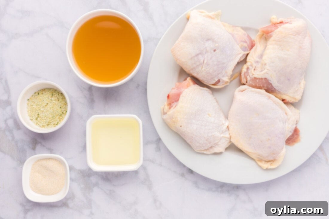 All ingredients laid out for making Instant Pot Chicken Thighs, including chicken, spices, and olive oil.