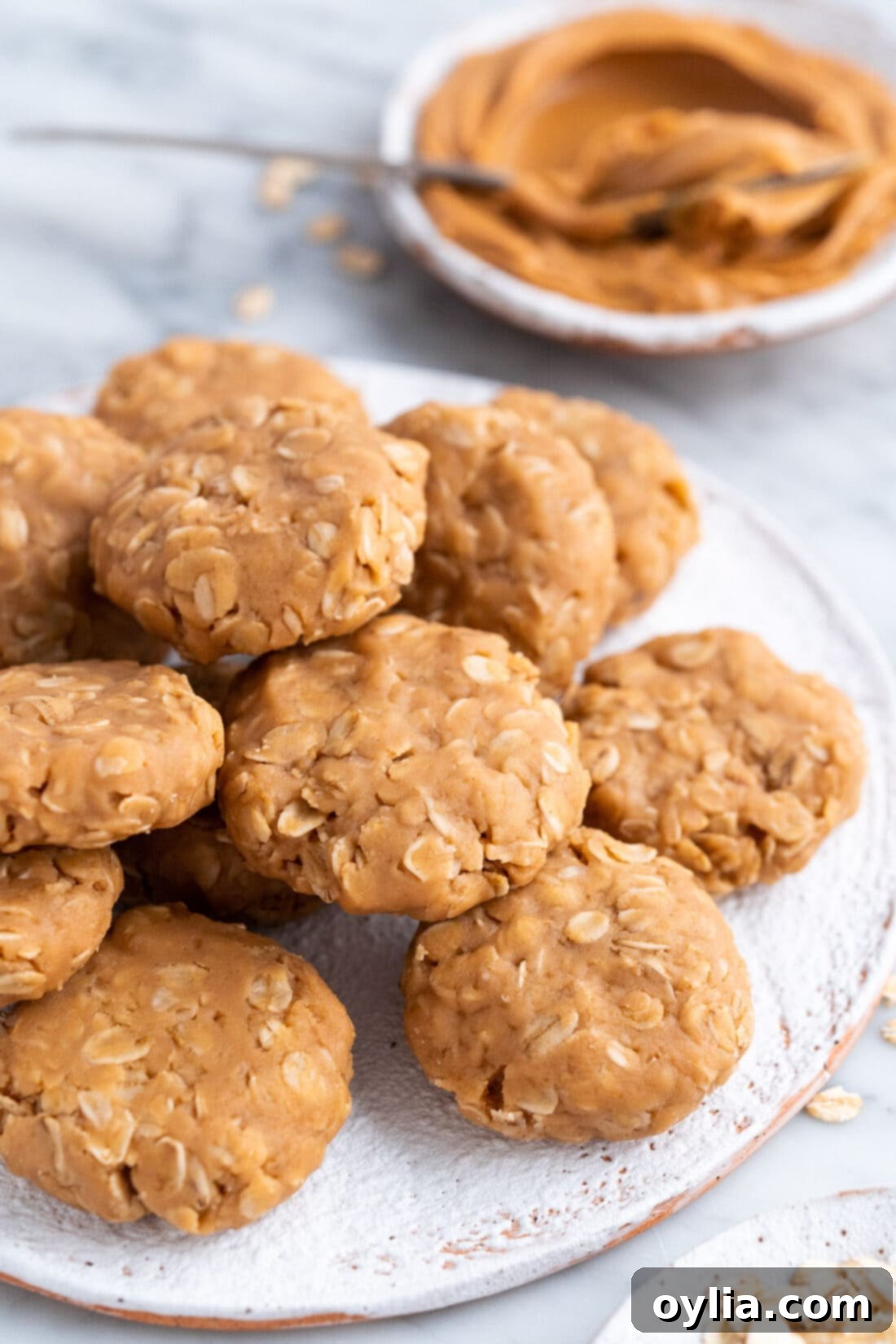 No Bake Peanut Butter Cookies on a plate with peanut butter in the background