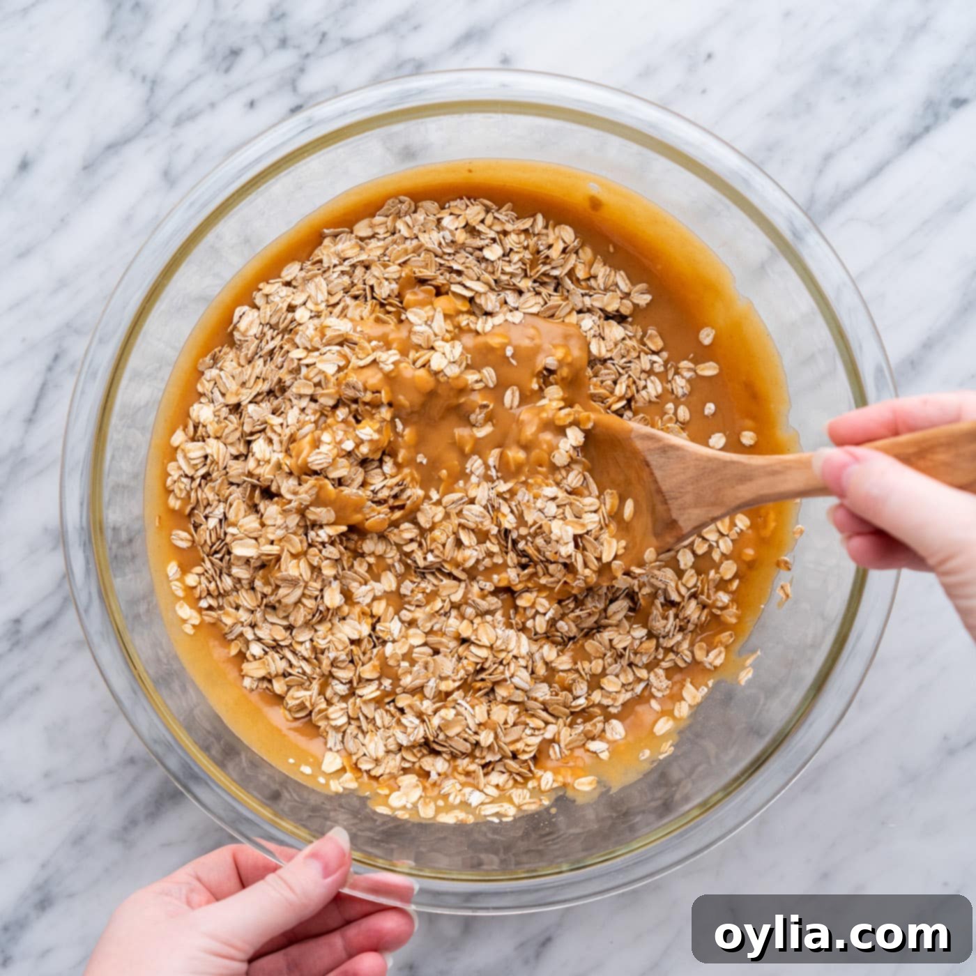 stirring oats into peanut butter mixture