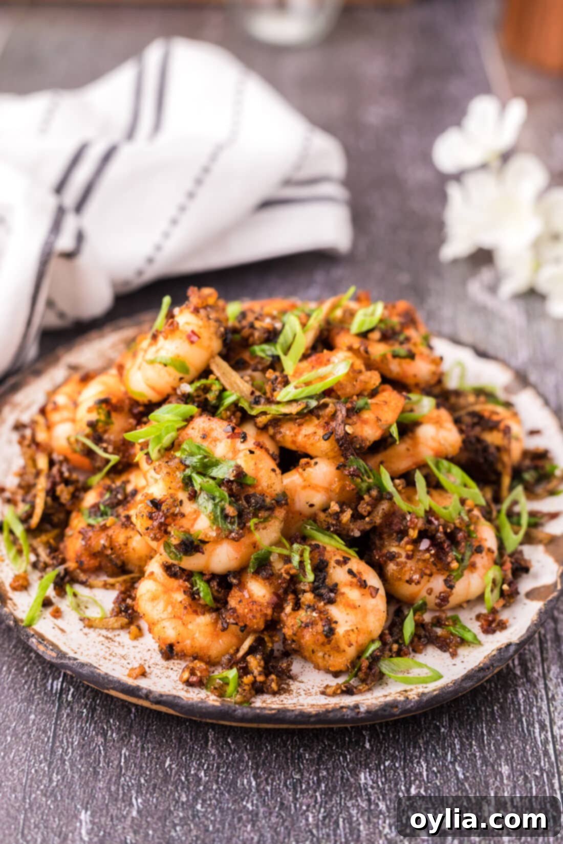 Plate of Salt and Pepper Shrimp, showcasing its crispy texture and garnish.