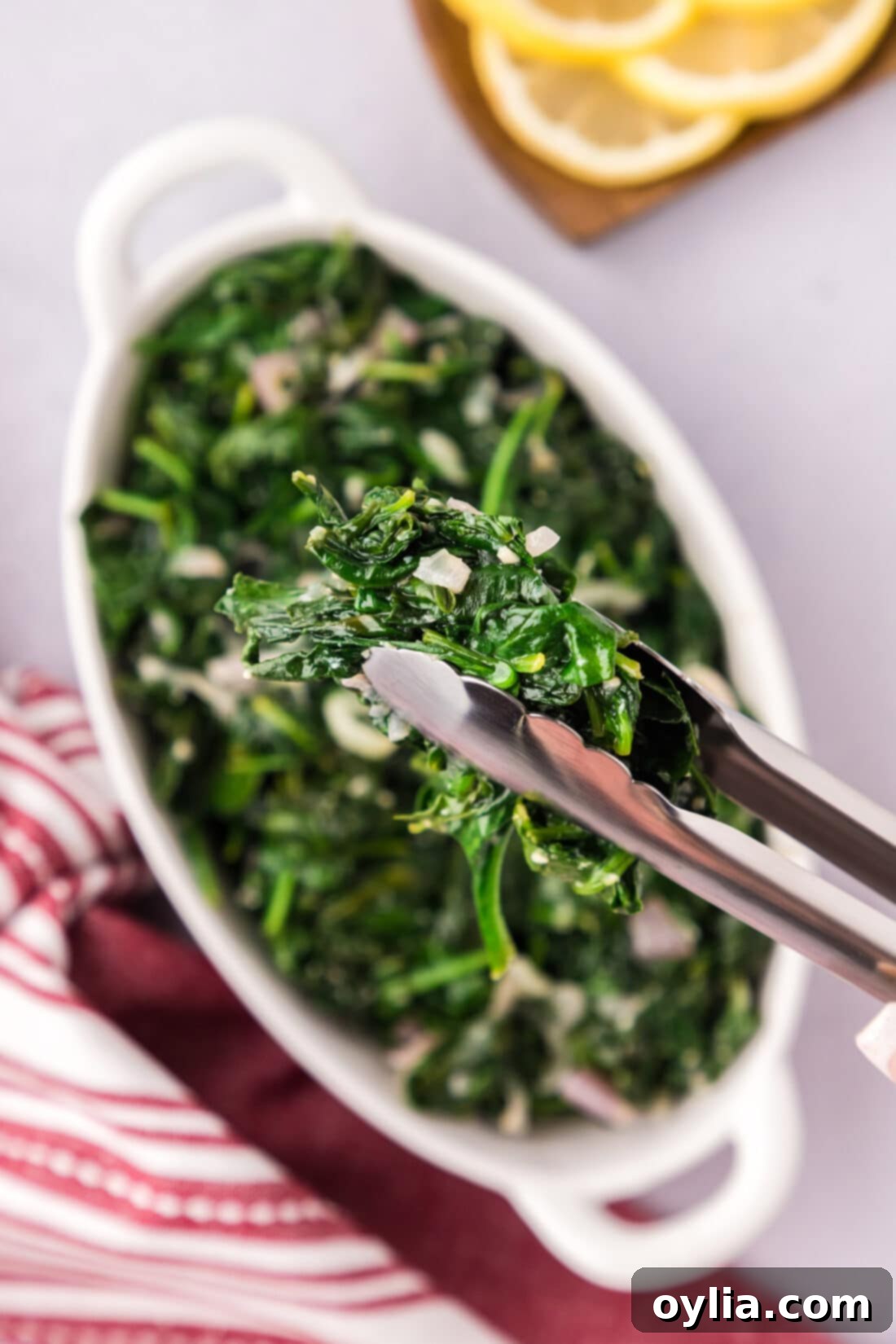 Garlicky Sautéed Spinach 2 Sautéed Spinach in a pair of tongs, ready to be served