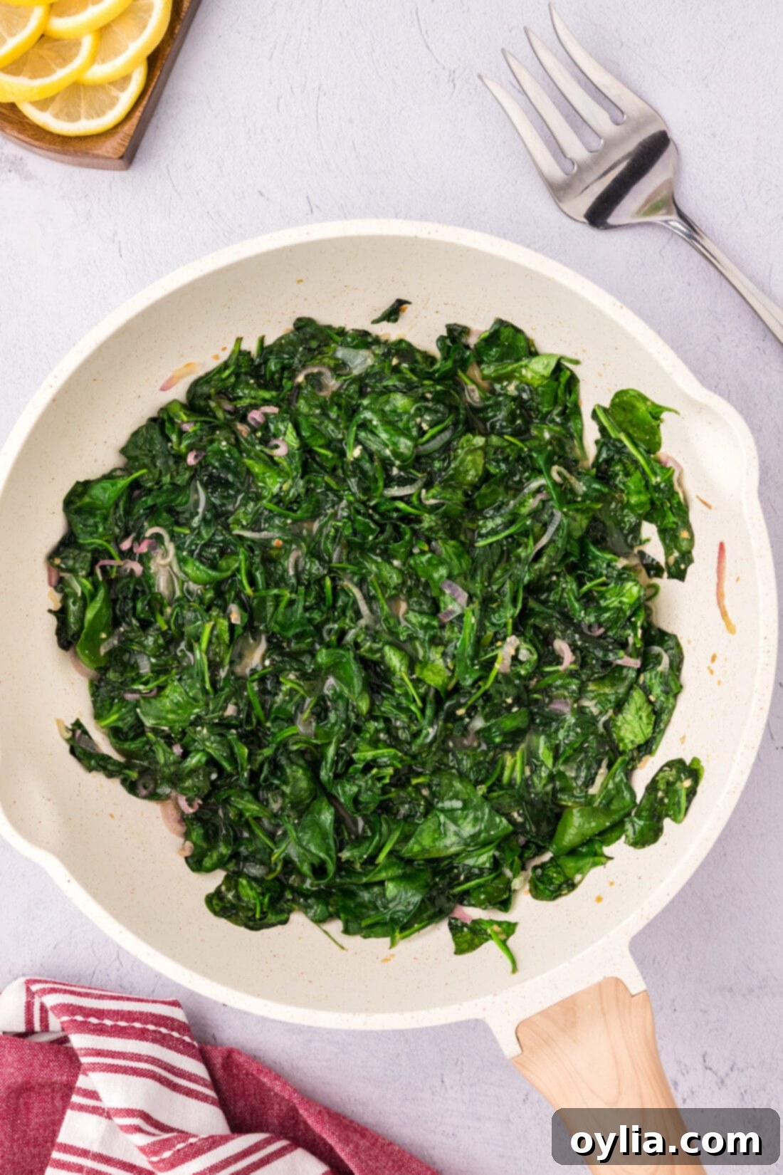 Garlicky Sautéed Spinach 3 Sautéed Spinach in a skillet with a wooden spoon
