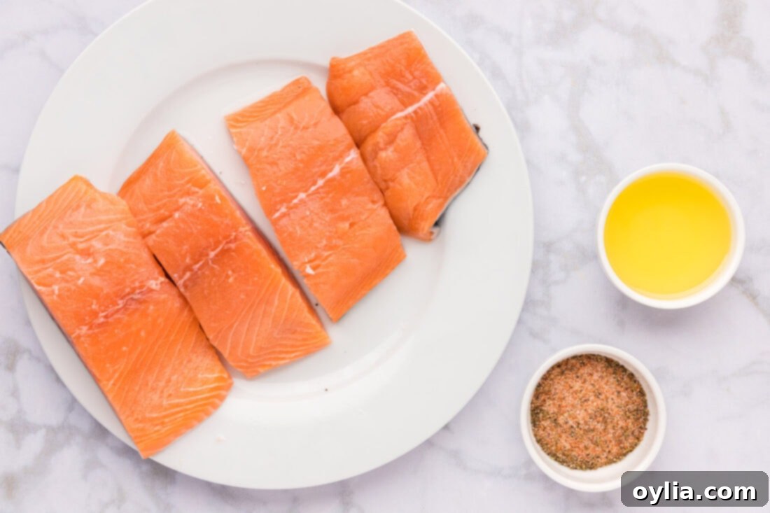 All the essential ingredients for Cajun Salmon laid out on a wooden board
