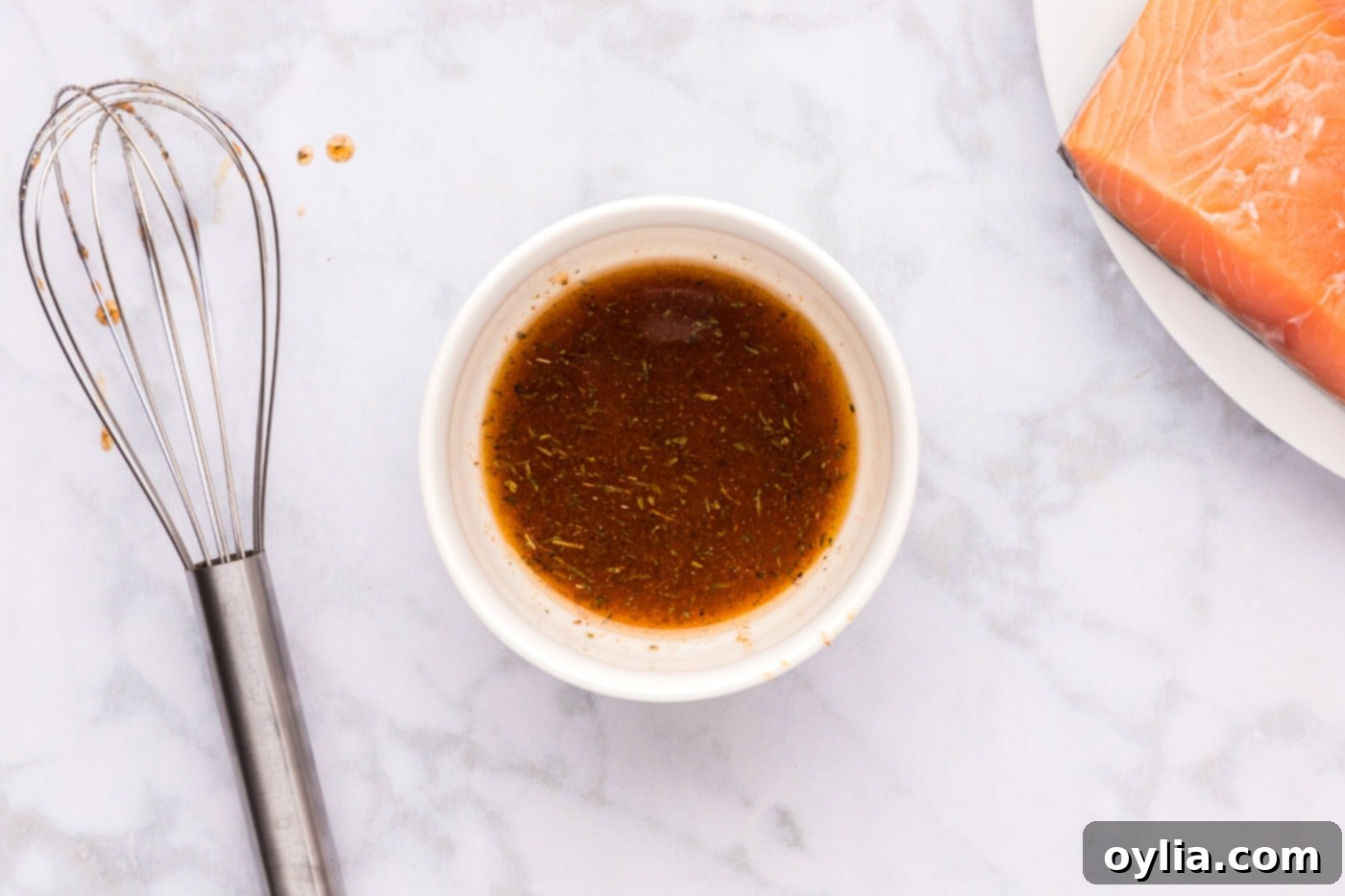 Olive oil mixed with Cajun seasoning in a small bowl, forming a vibrant paste