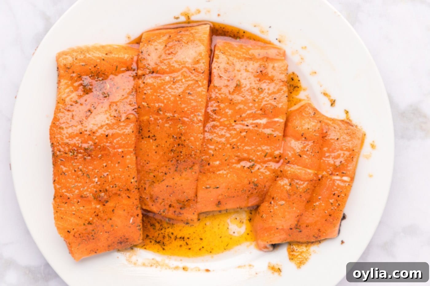 Raw salmon fillets coated with Cajun seasoning and olive oil mixture