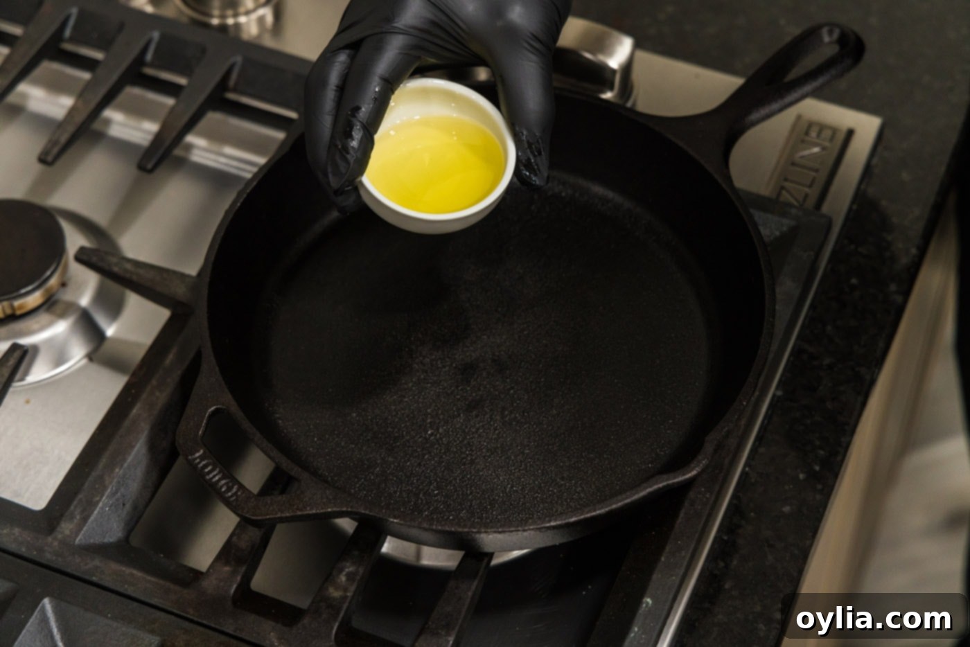 Olive oil shimmering in a hot skillet on the stovetop
