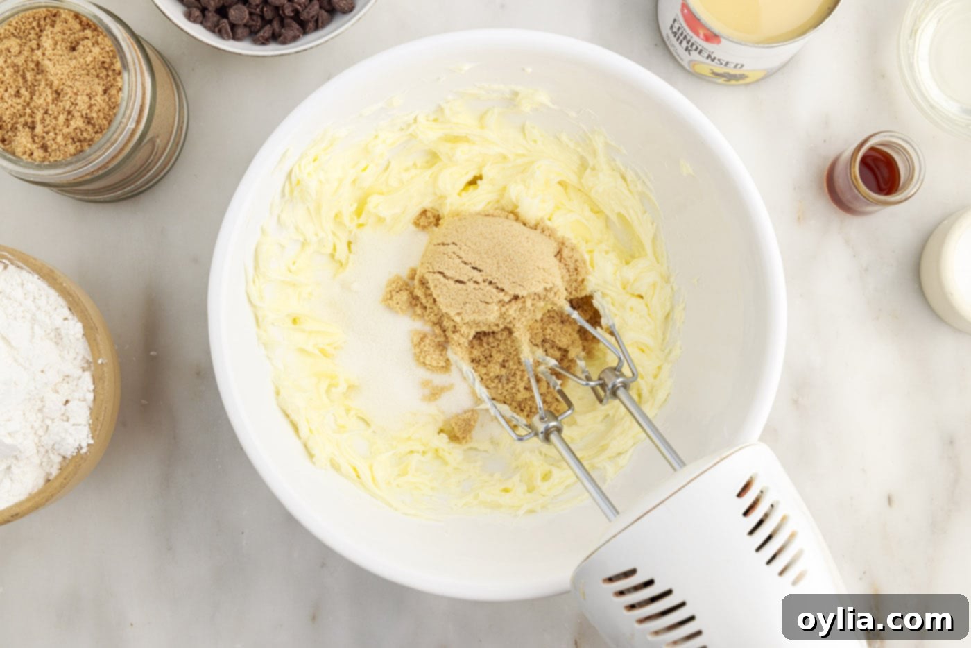 Beating softened butter and sugars together with a hand mixer in a large bowl until light and fluffy.