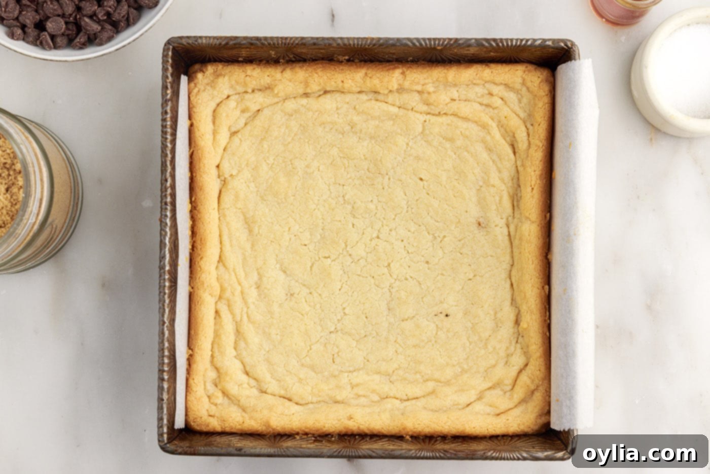 The golden-brown, baked shortbread crust cooling in the pan after coming out of the oven.