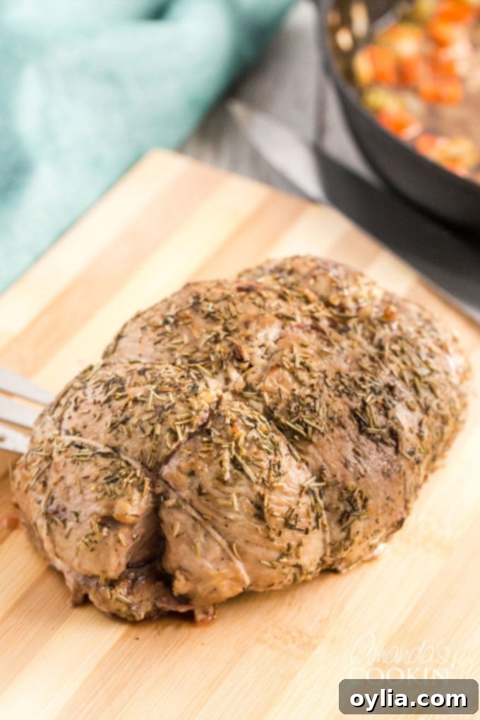 The Ultimate Sirloin Pork Roast Recipe 10 cooked pork roast on a wooden cutting board