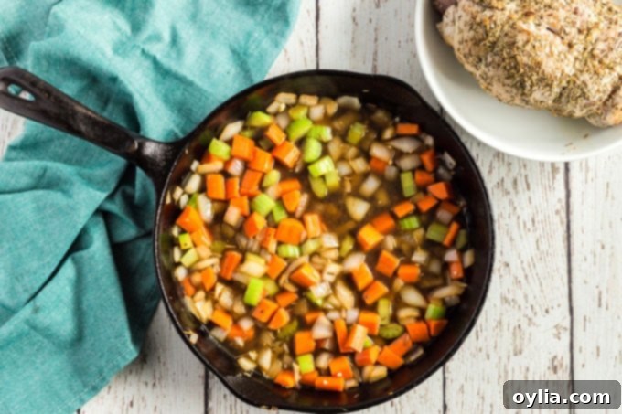 The Ultimate Sirloin Pork Roast Recipe 8 sauteed onions celery and carrots in a pan