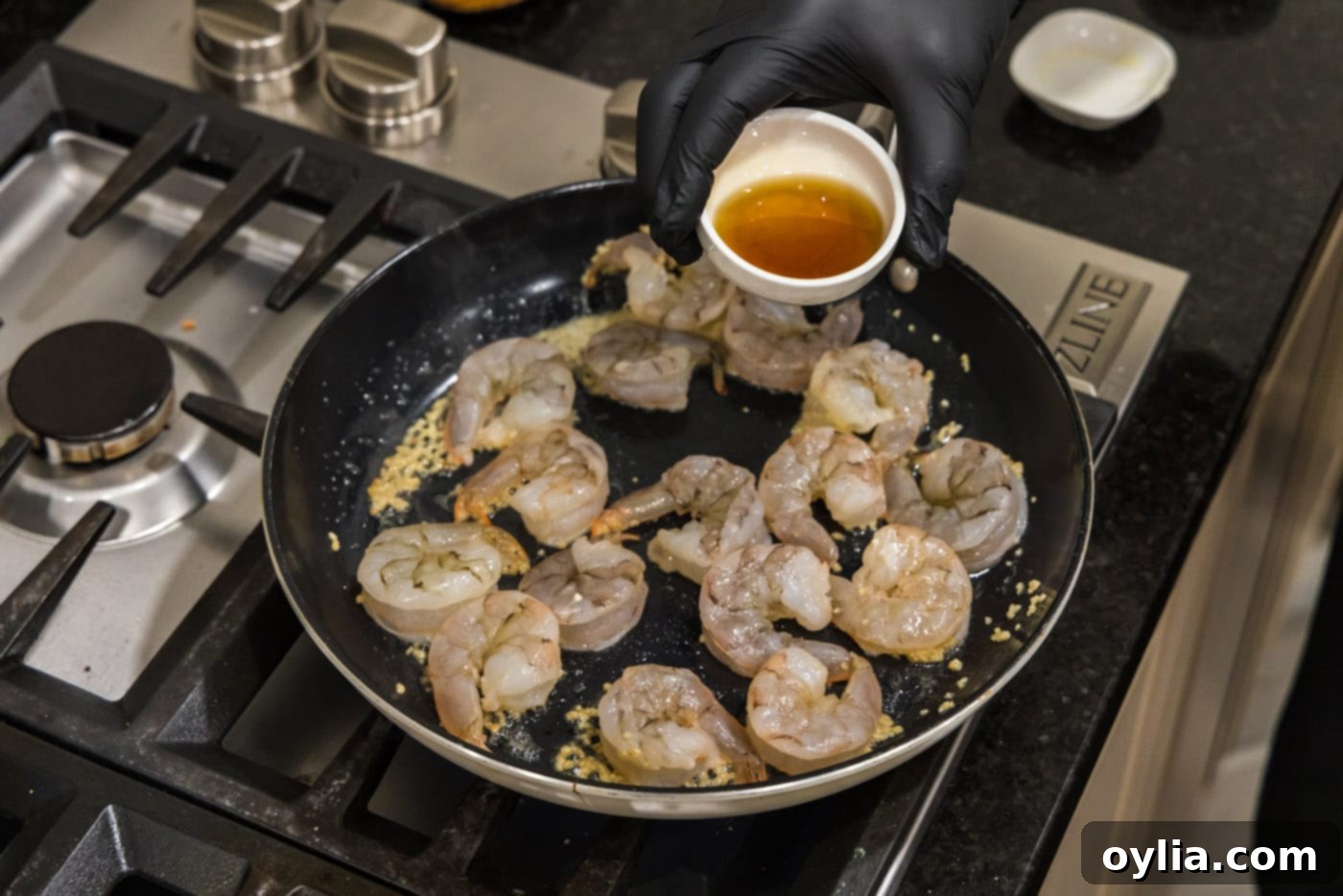 Pouring oyster sauce into the skillet with sizzling shrimp and garlic butter, adding depth and umami to the hibachi sauce.