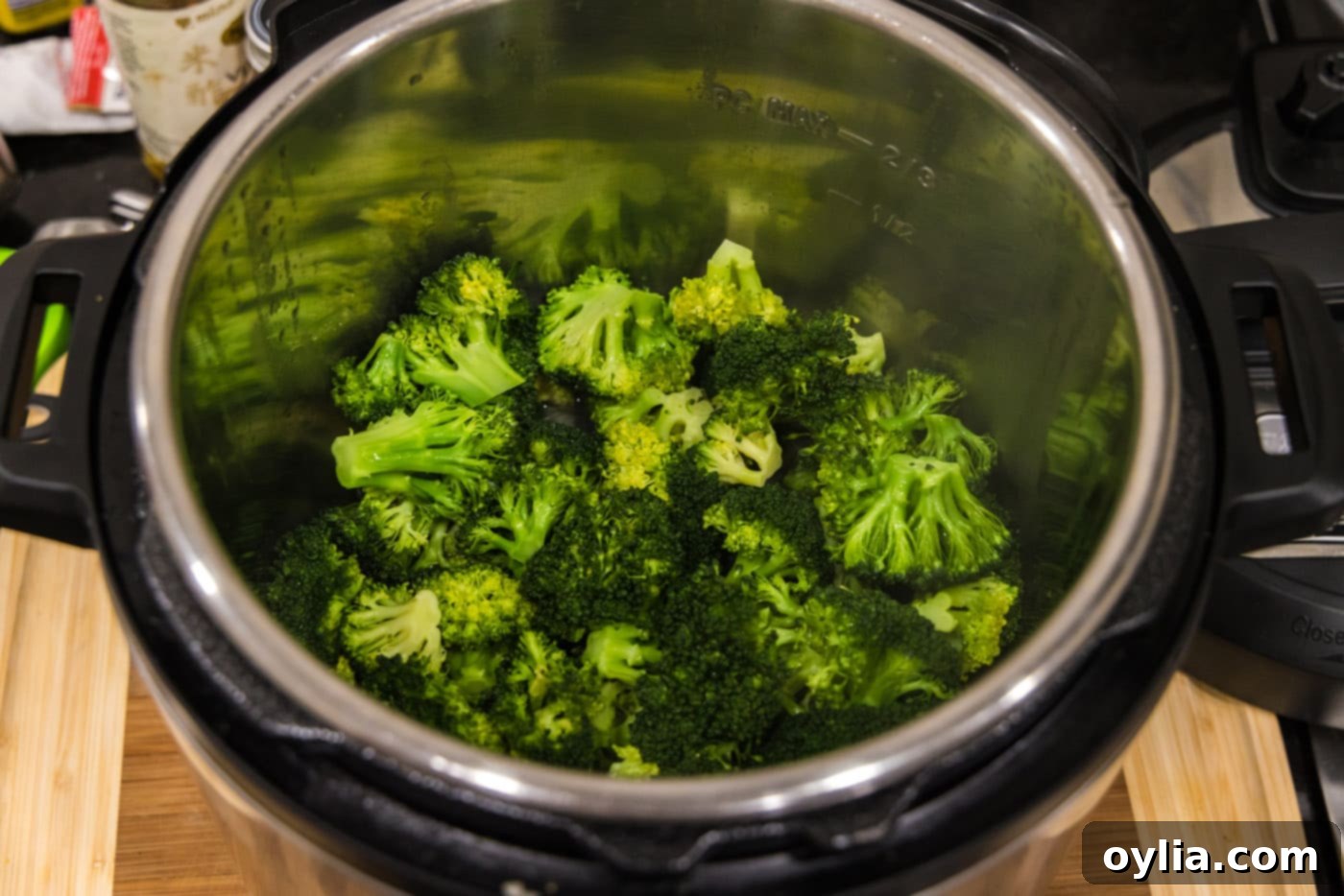 Steamed broccoli inside the Instant Pot after cooking, appearing bright green.