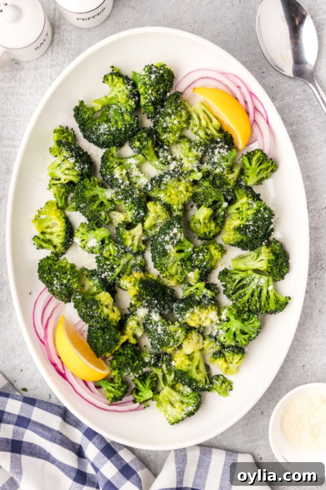 Platter of vibrant green Instant Pot Broccoli, ready to be served, garnished with fresh lemon.