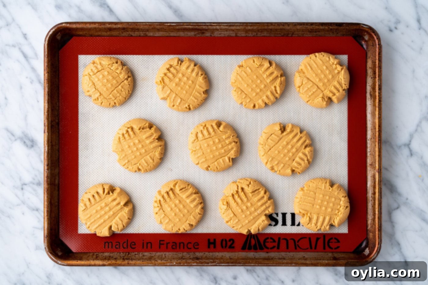 Freshly baked cake mix peanut butter cookies, golden brown and perfectly puffed, cooling on a baking sheet.