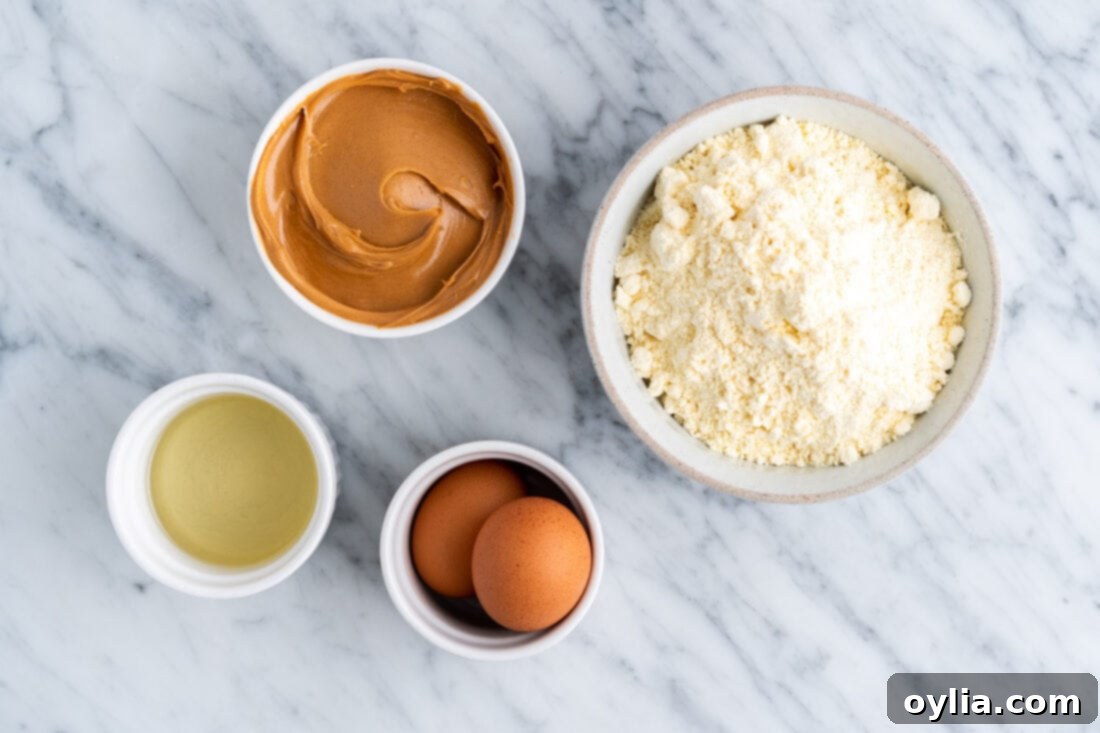 Simple Peanut Butter Cake Mix Treats 4 The four simple ingredients laid out for Peanut Butter Cake Mix Cookies: yellow cake mix, creamy peanut butter, eggs, and vegetable oil.