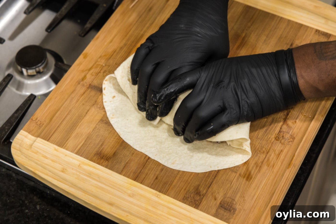 hands rolling a burrito
