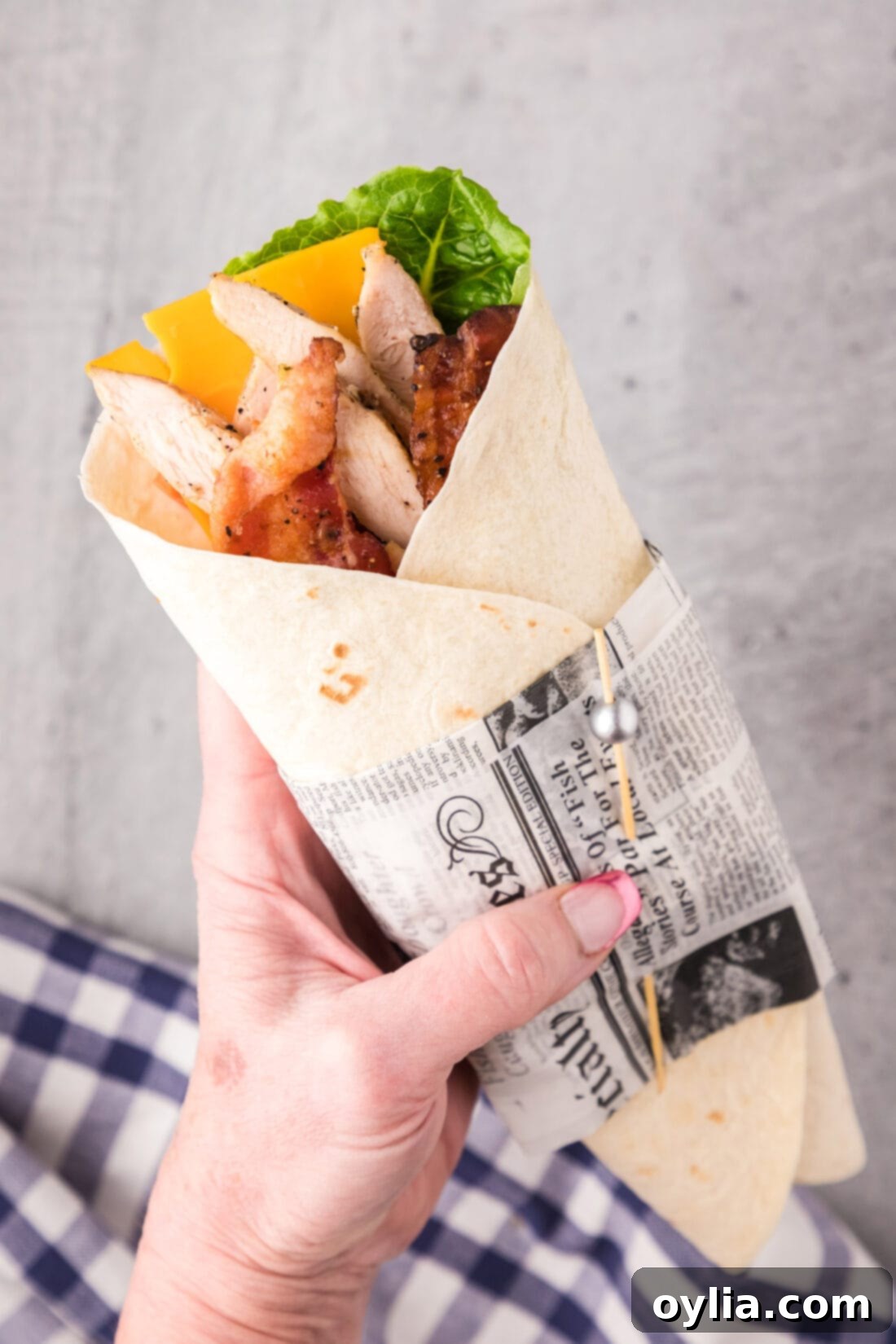 Hand holding a Chicken Bacon Ranch Wrap
