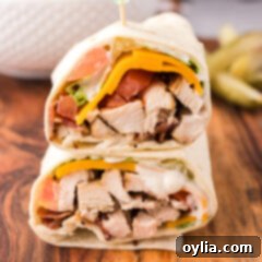 Close up photo of a Chicken Bacon Ranch Wrap cut in half and stacked on top of eachother