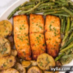 Close up photo of Brown Sugar Salmon served on a platter with garlic green beans and melting potatoes