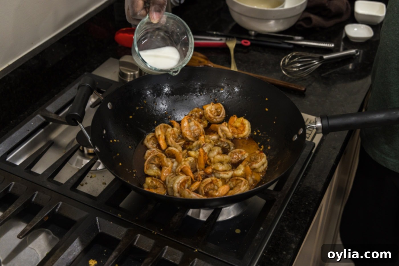 pouring a cornstarch slurry into hunan shrimp