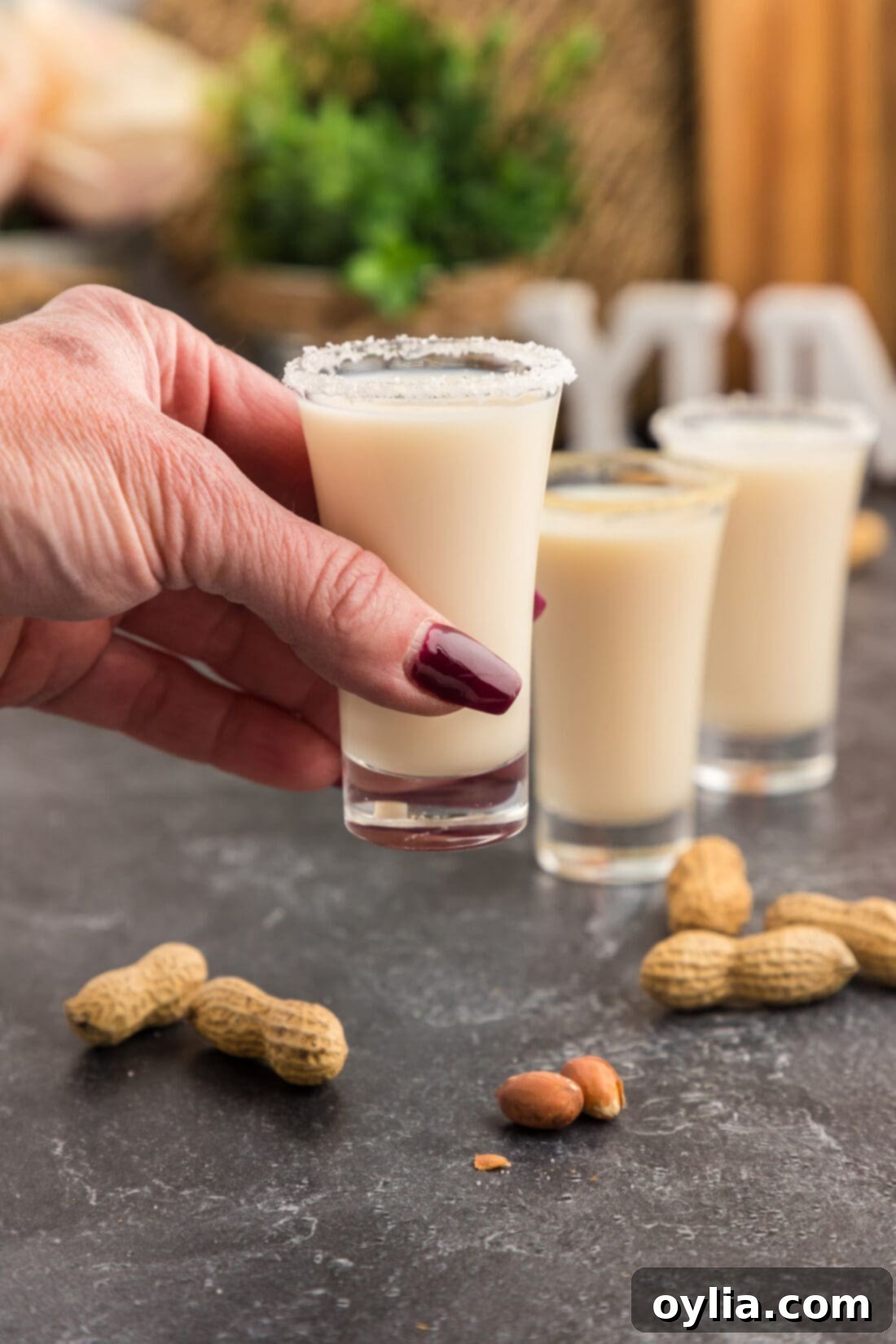 Hand holding up a Salted Nut Roll Shot