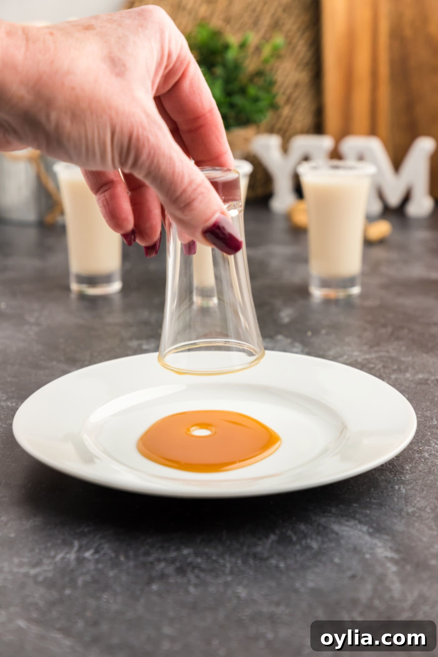 dipping shot glass into caramel