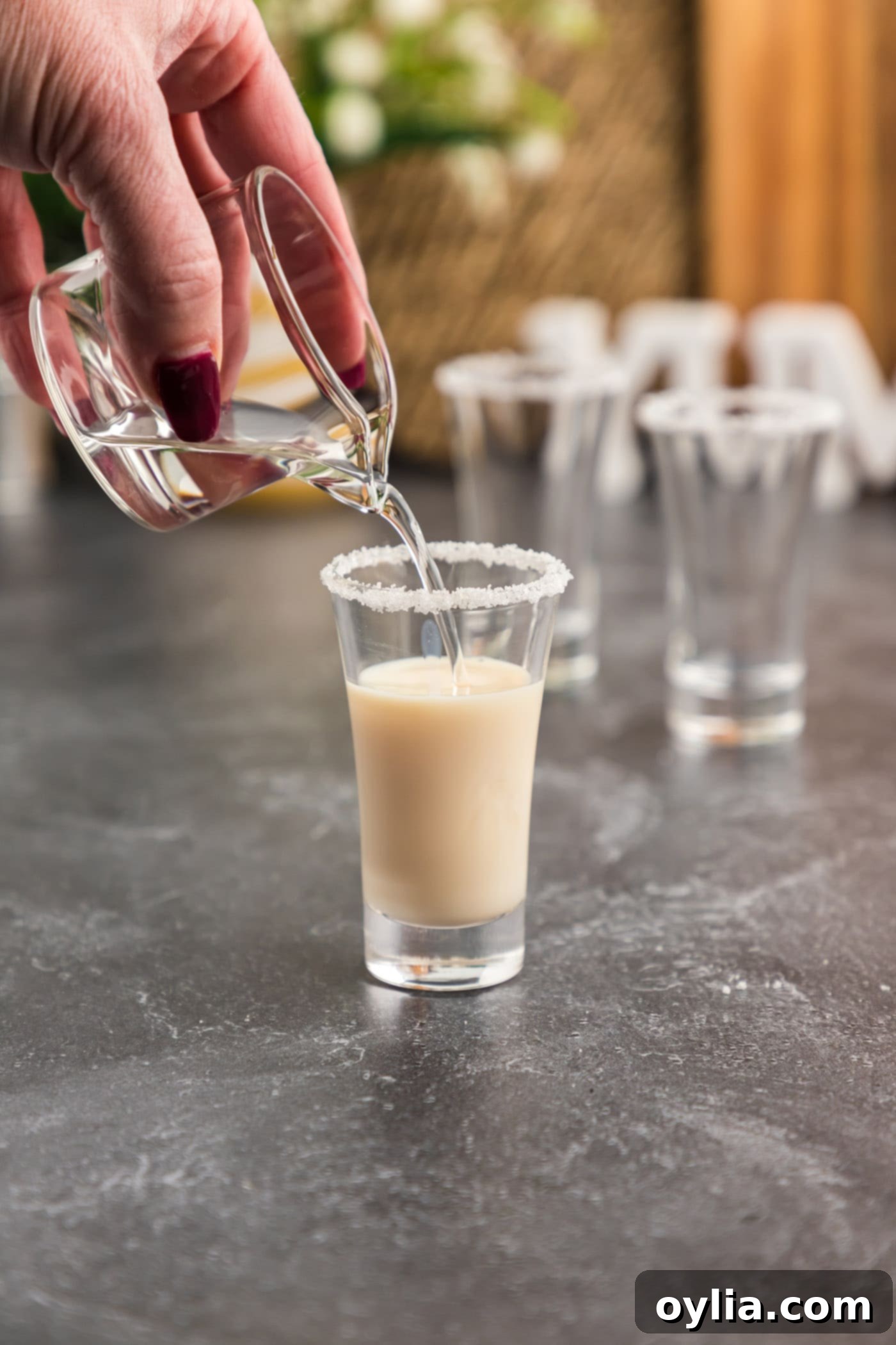 pouring butterscotch schnapps into shot glass
