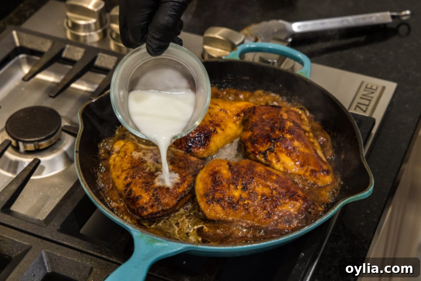 adding cornstarch slurry to skillet with chicken and sauce