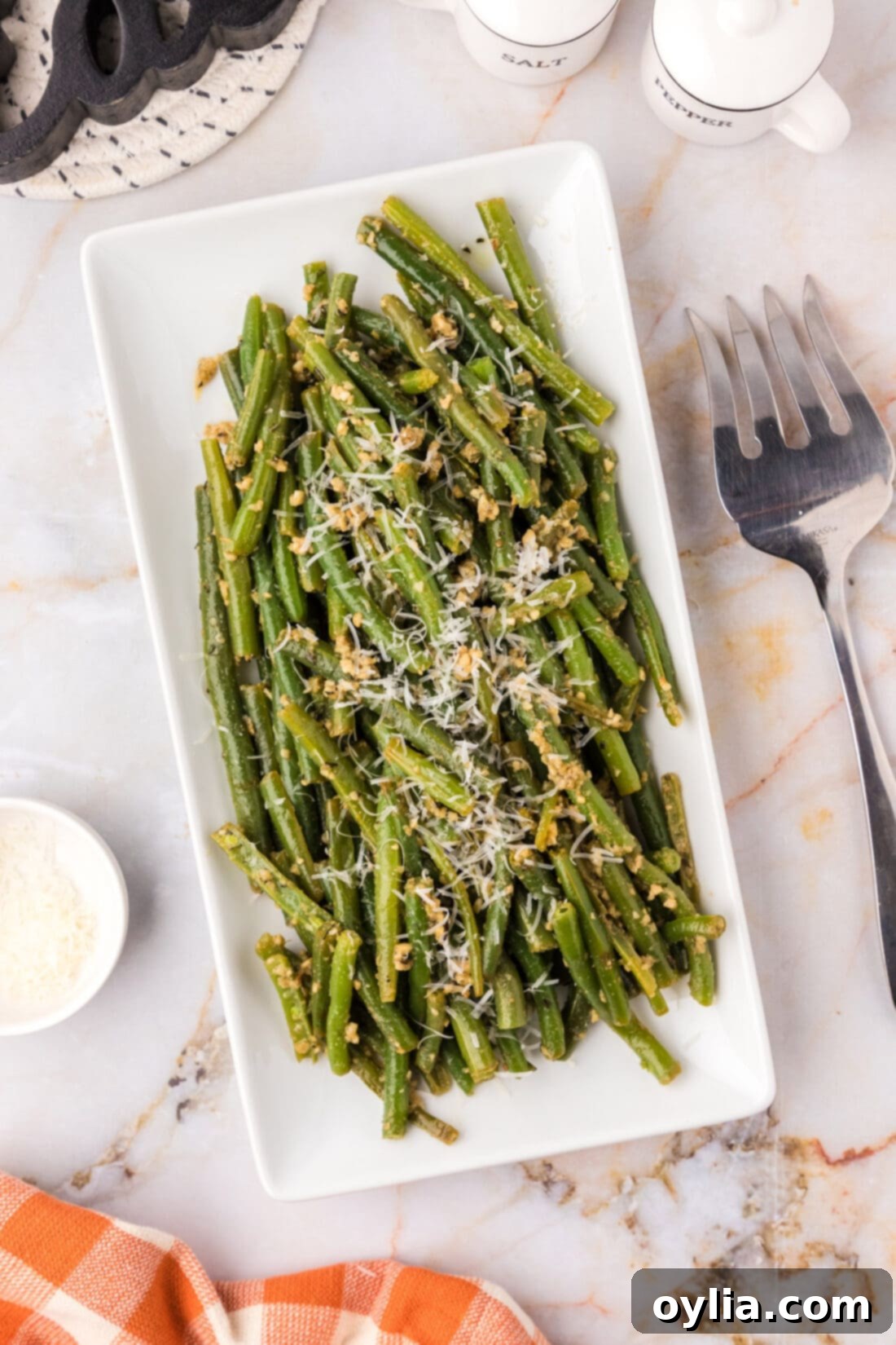 Garlic Green Beans on a platter garnished with parmesan