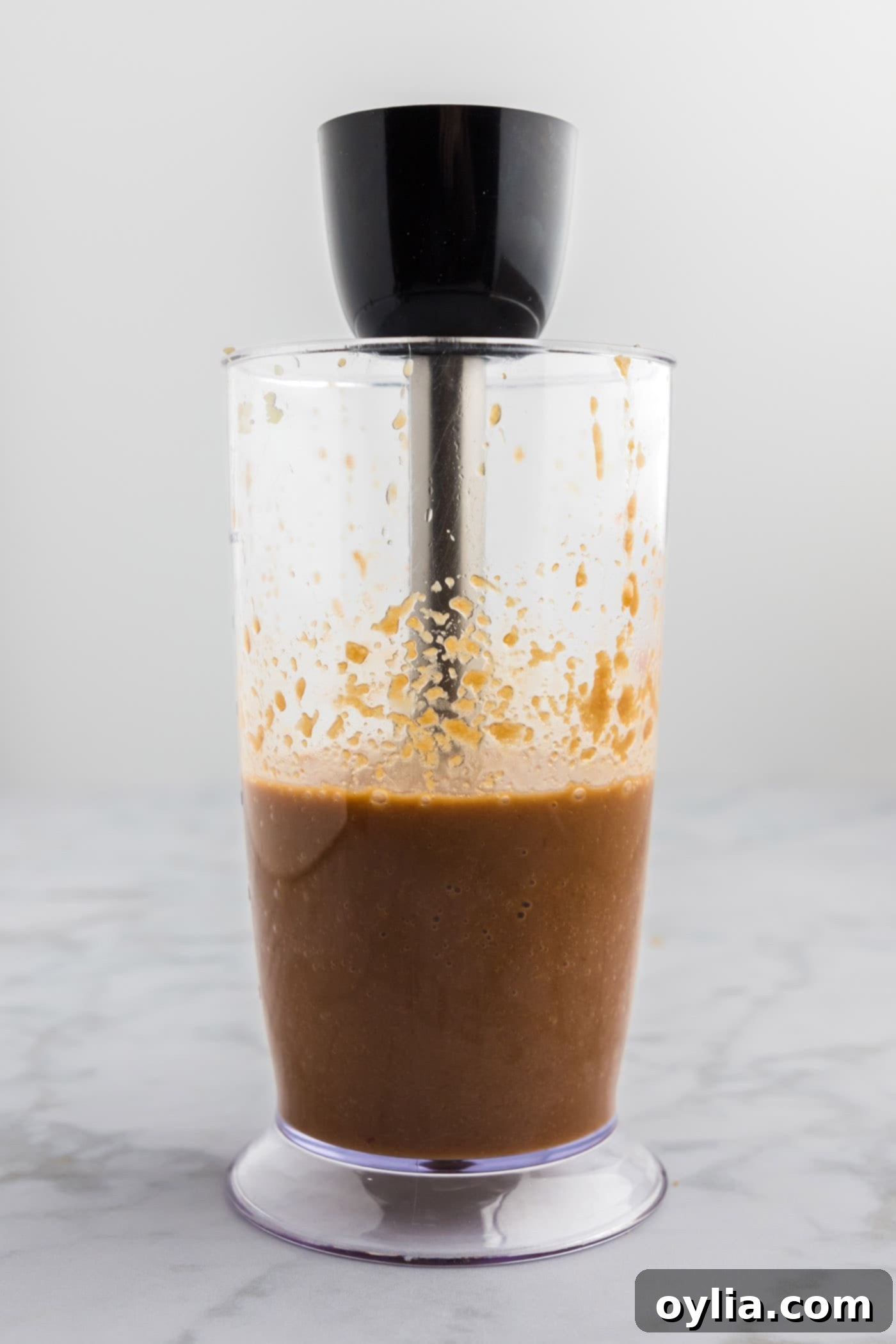 An immersion blender actively blending the bulgogi marinade until smooth.
