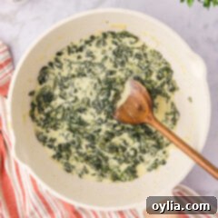 Decadent Creamed Spinach 12 Skillet of Creamed Spinach with a spoon in it