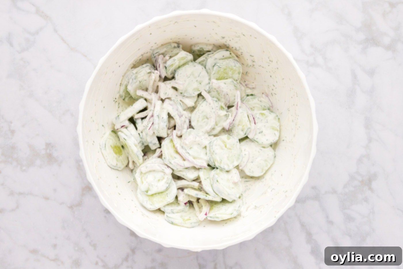 creamy cucumber salad mixed in a bowl