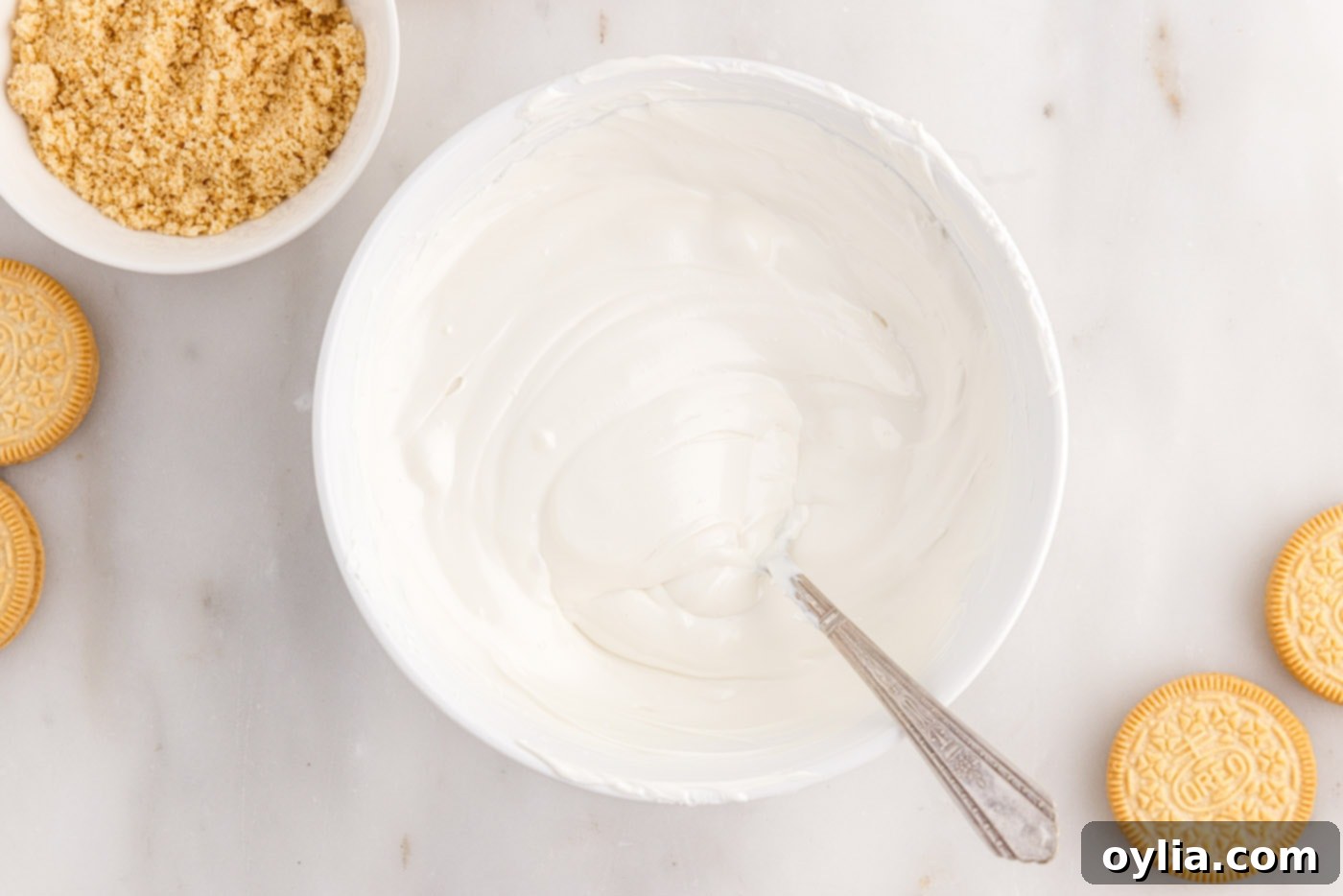 Melted and smooth white chocolate wafers in a bowl