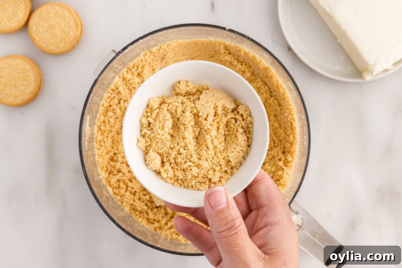Two tablespoons of Golden Oreo cookie crumbs reserved in a small bowl for decoration
