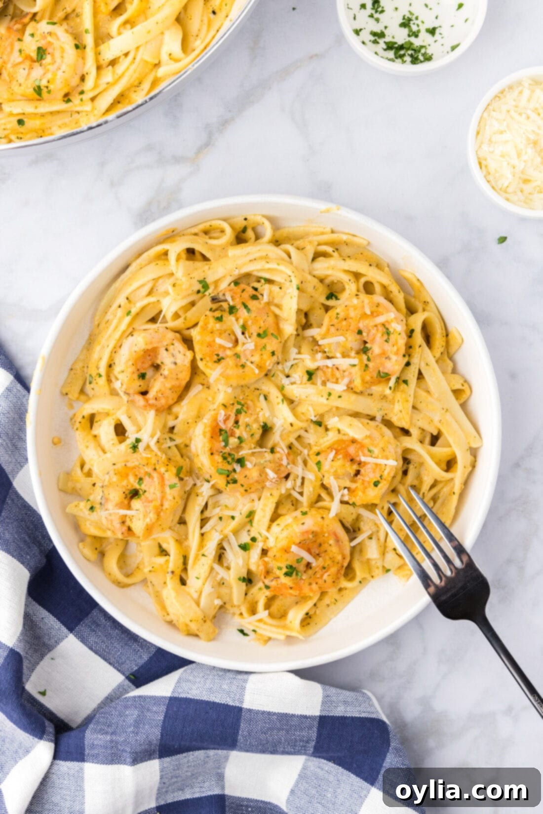 A generous bowl of homemade shrimp alfredo pasta, ready to be served