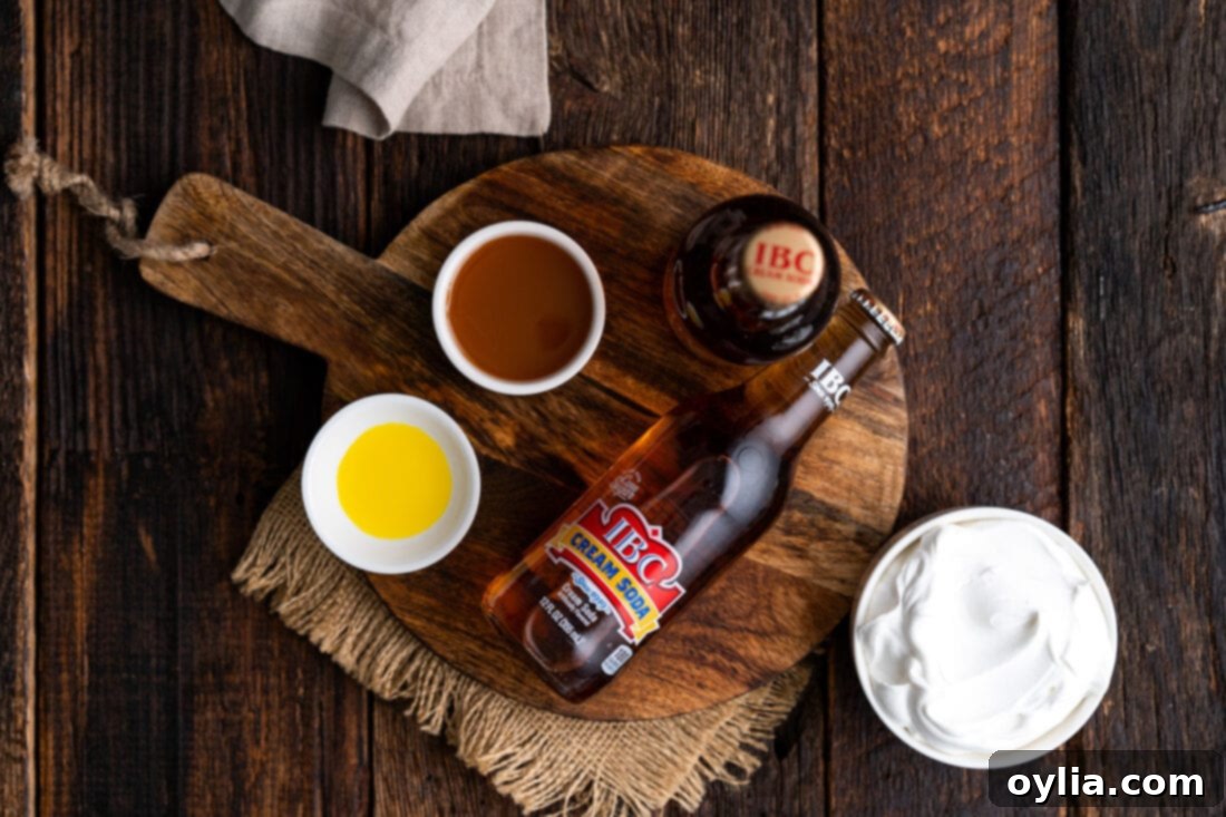 A collection of ingredients for Butterbeer, including cream soda bottles, butterscotch syrup, and a small bottle of butter extract.