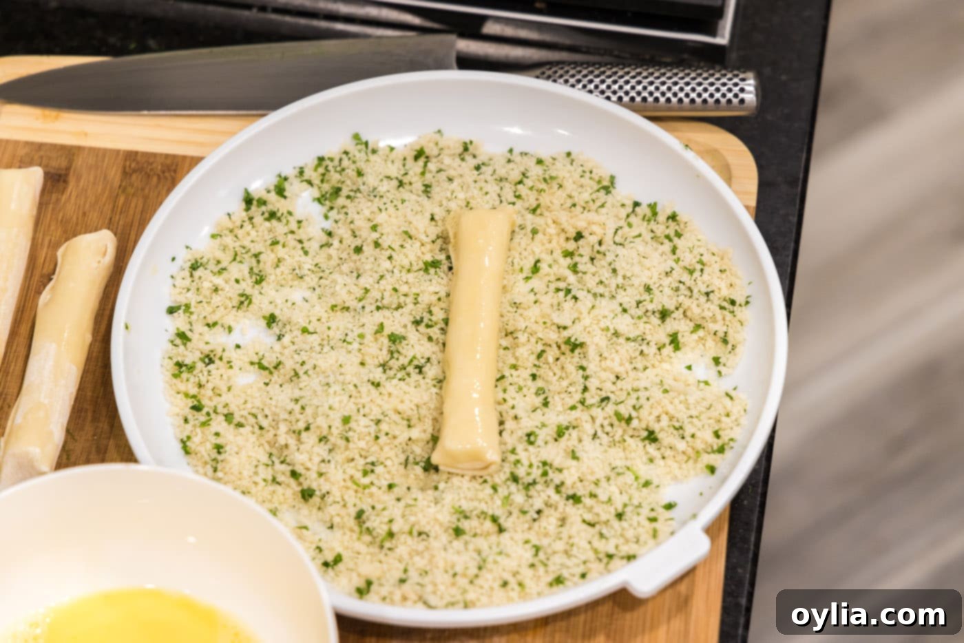 rolling mozzarella sticks in panko breadcrumbs