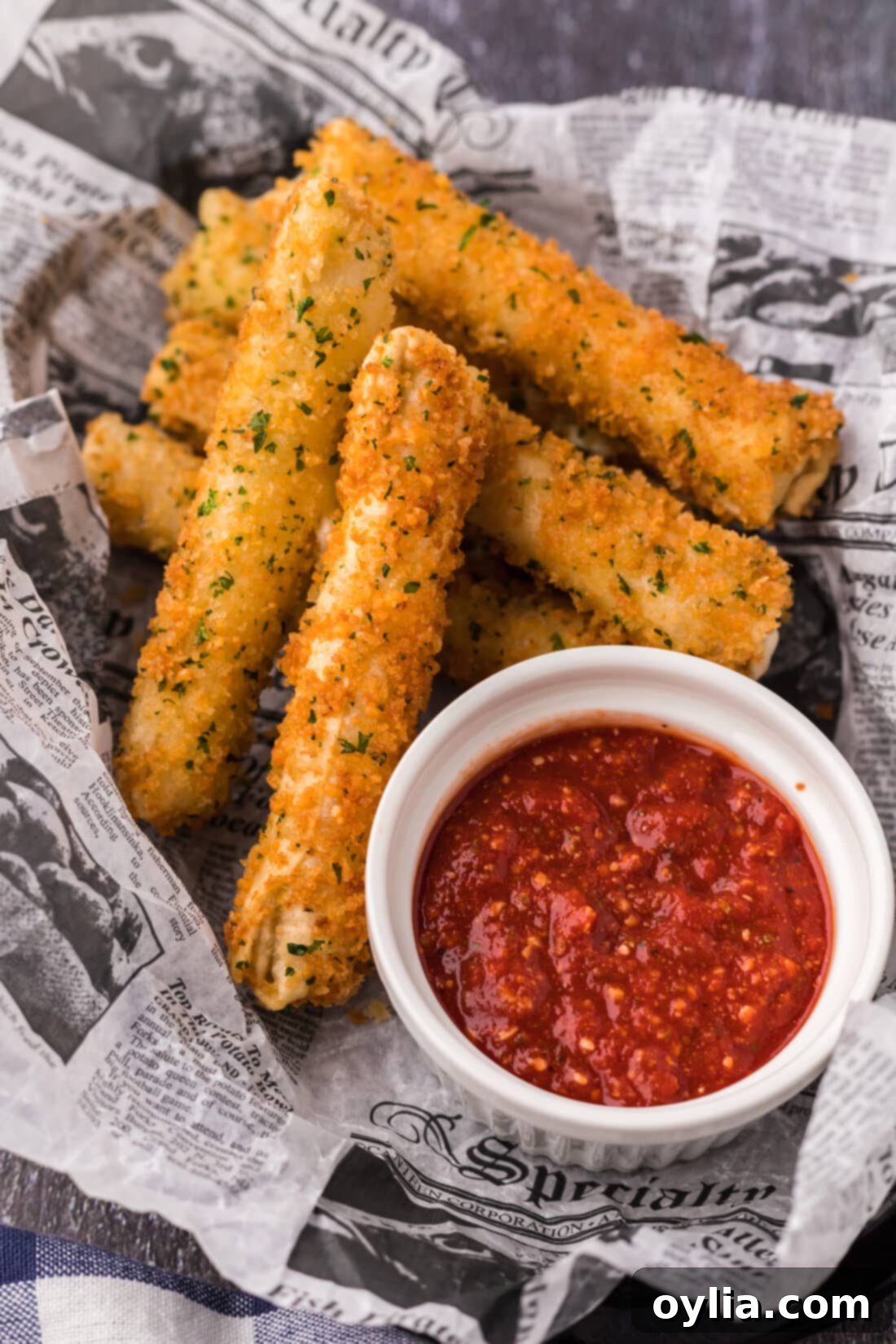Basket of Wonton Cheese Sticks with a cup of marinara sauce