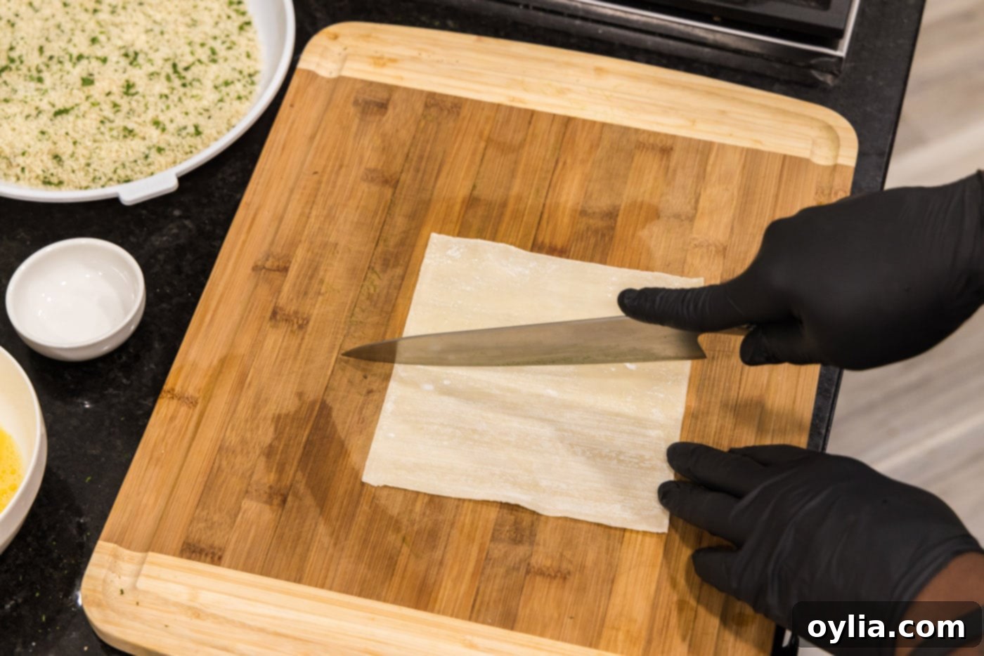 slicing egg roll wrapper in half