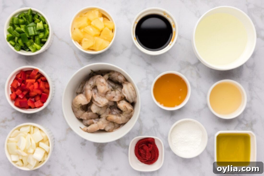 All ingredients for homemade Sweet and Sour Shrimp laid out on a wooden cutting board.