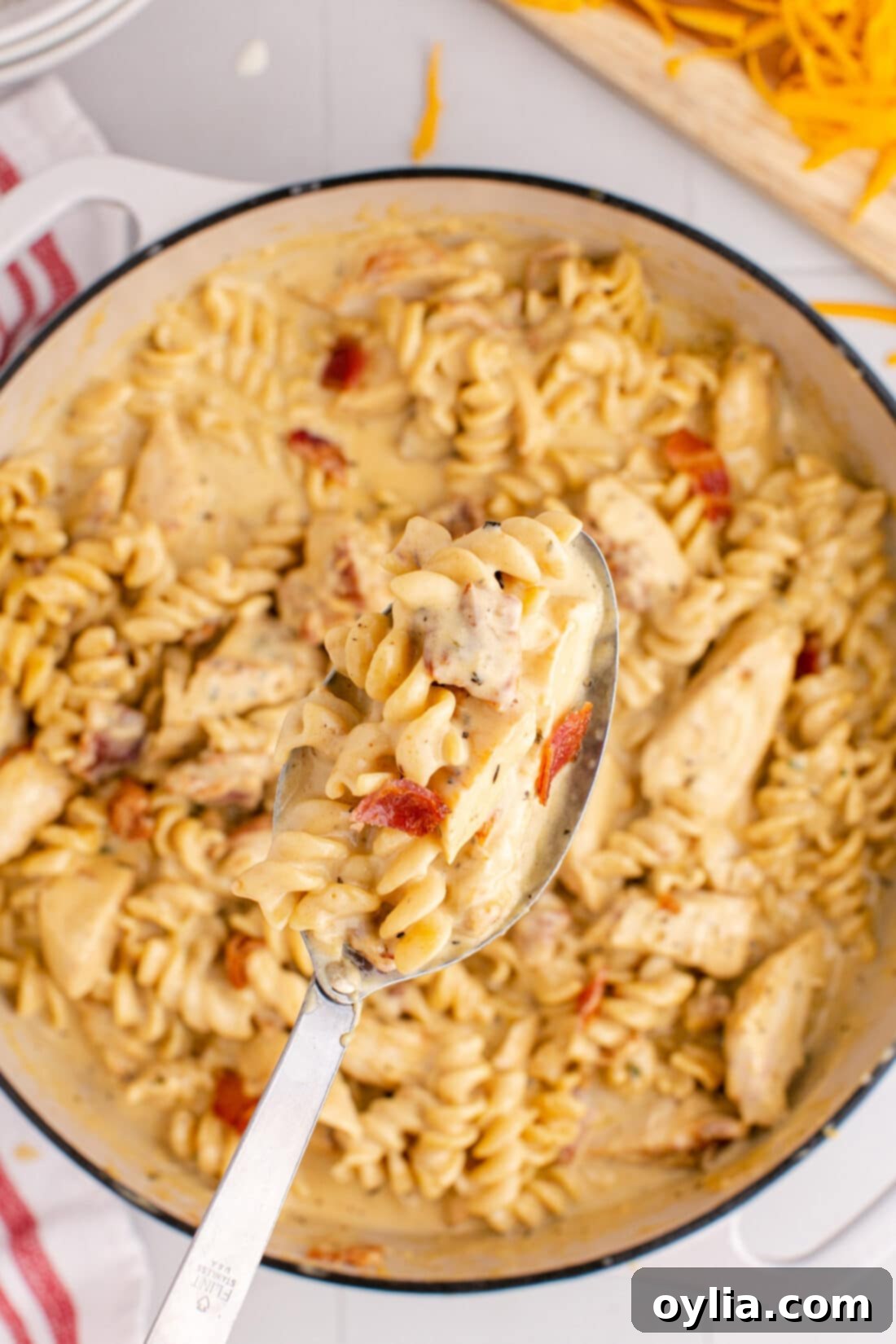 Spoonful of Bacon Chicken Ranch Pasta being lifted out of the pot of Bacon Chicken Ranch Pasta